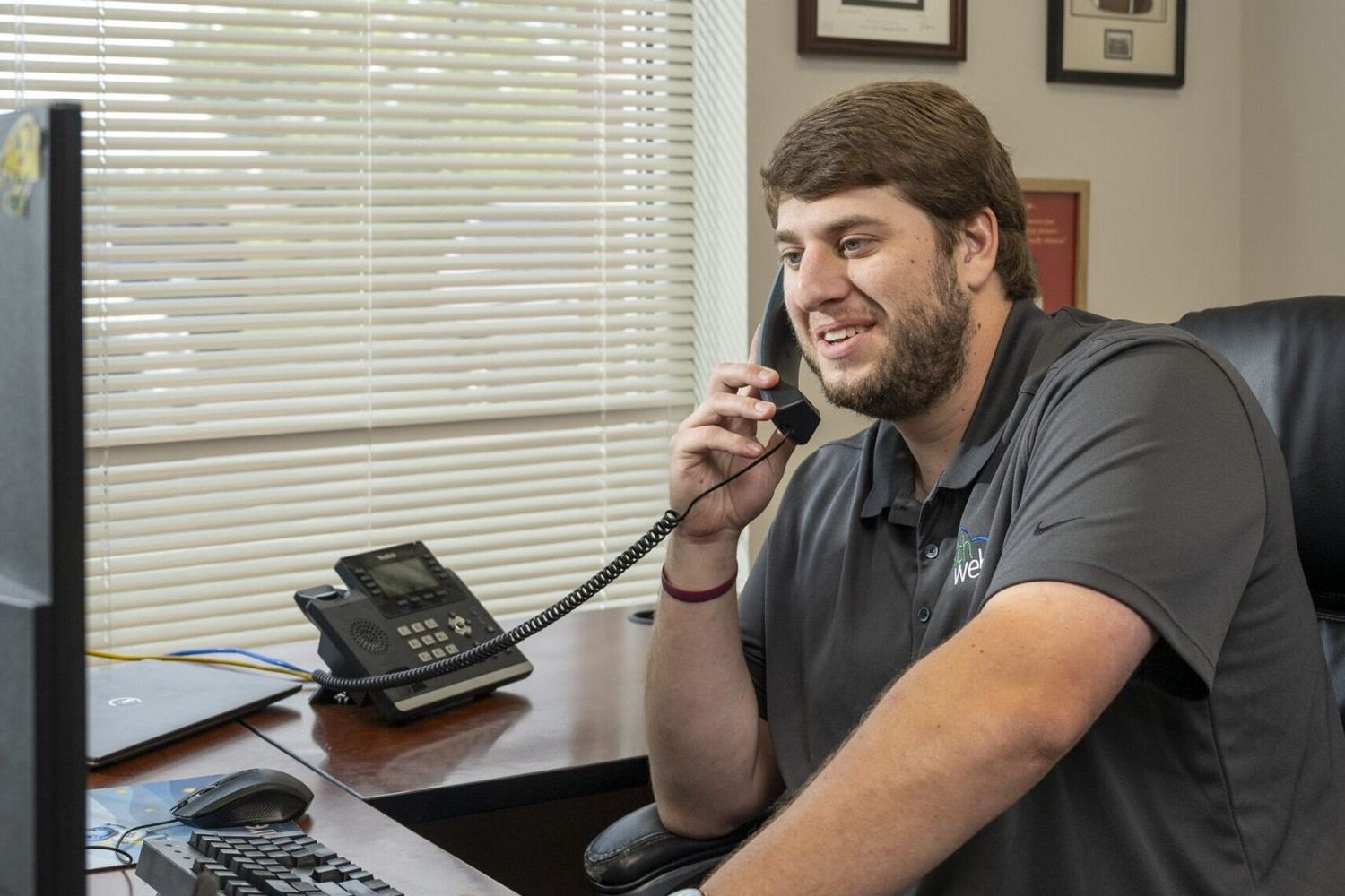 A Richweb engineer taking a customer call at his desk in Ashland, Virginia